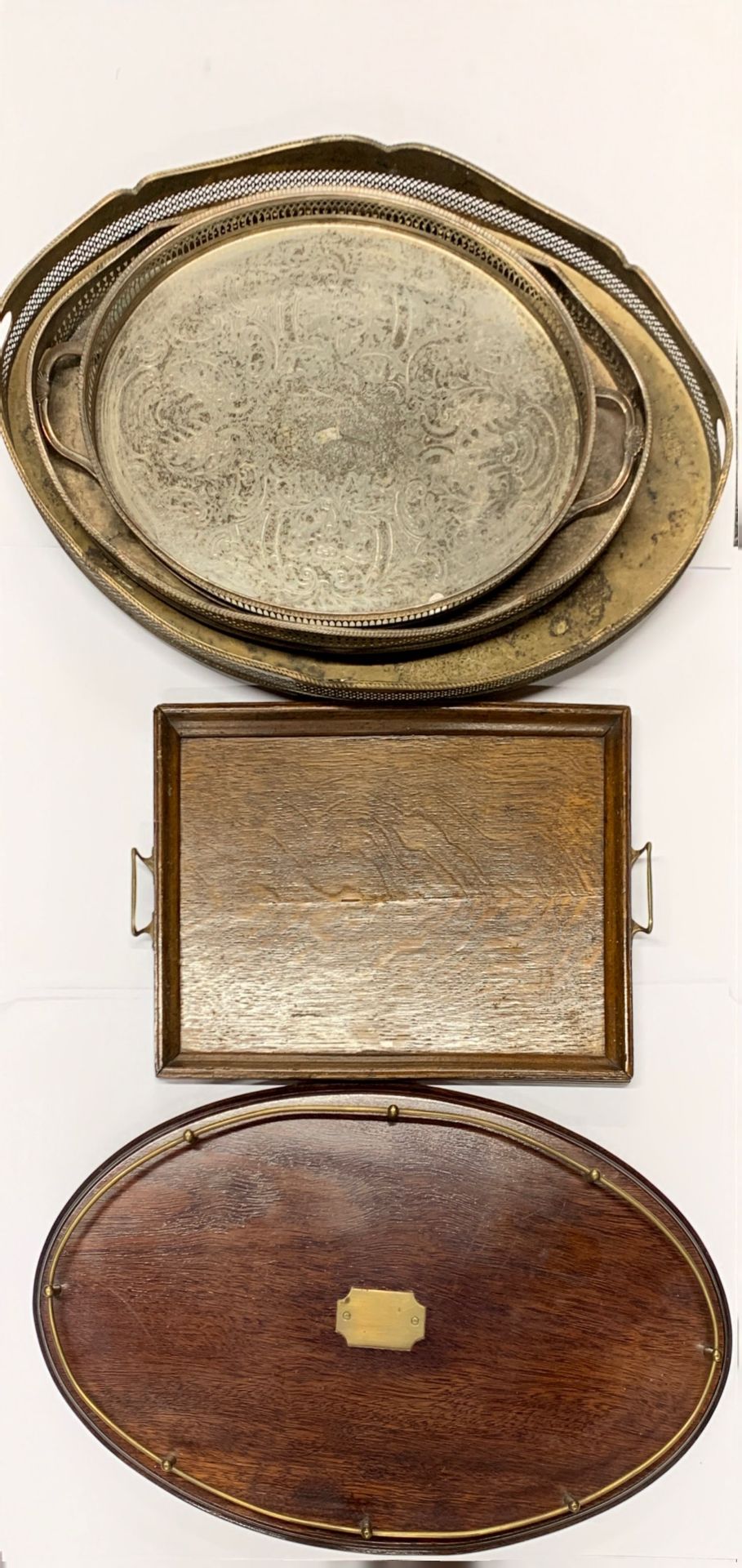 Three silver plated gallery trays, largest 60cm, together with two wooden trays.