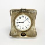 A white metal cased travelling clock, 7.5 x 8.5cm.