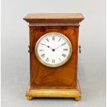 An Edwardian walnut mantel clock.