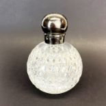 A large hallmarked silver top cut crystal dressing table bottle, H. 15cm.