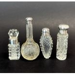 A group of four small silver mounted cut crystal bottles (three with hallmarked one unmarked but