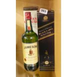 Two bottled of Johnny Walker black label whiskey with a further bottle of Famous Grouse and