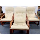 A set of four button backed cream armchairs, H. 102cm Some minor tears.