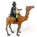 An Austrian cold painted bronze figure of an Arab riding a camel, stamped to base (possibly