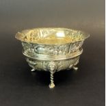 A heavy Chester hallmarked silver embossed bowl raised on three lion head and paw feet, Dia. 11.5cm.