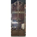 A painted metal garden mirror with gate style front, H. 128cm. Closed W. 52cm.