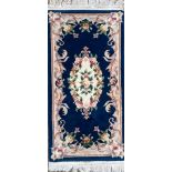 A Chinese blue ground wool rug, 162 x 69cm.