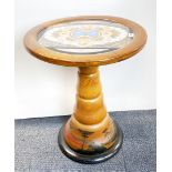 A mid-20th Century South American circular wooden table decorated with butterfly wings, Dia. 54cm.