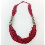 A Tibetan carved bone and coral bead necklace, folded L. 39cm.