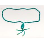 A single strand necklace of reconstituted turqoise beads, bead size 7.5mm. Folded L. 54cm.