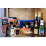 A group of miniature bottles of alcohol with a vintage ice bucket and other items.