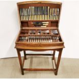 An oak standing cutlery case containing a set of silver plated cutlery, 84 x 69 x 45cm.