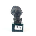 A small bronze bust mounted on a green marble base, H. 12.5cm.