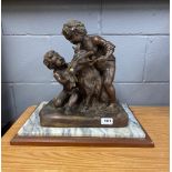 A bronze figure of two Putti feeding grapes to a goat on a marble and wood base, statue size 30 x 22