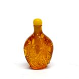 A Chinese reconstitued amber snuff bottle, H. 6.5cm.