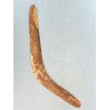 An old carved hardwood aboriginal boomerang, W. 57cm. Small drill hole.