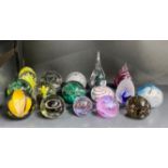 A group of Caithness and other paperweights.