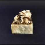 A Chinese carved hardstone scholars seal mounted with a young dragon, 4 x 3.5 x 4.5cm.
