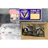 A box of vintage motor car related mascots and other items.