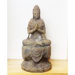 A Chinese carved wooden figure of the goddess Guanyin seated on a draped dais, H. 51cm.