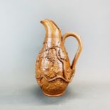 A 19th Century glazed pottery wine jug, H. 29cm.