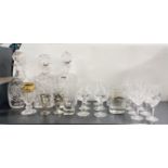 Three cut glass decanters and other glassware.