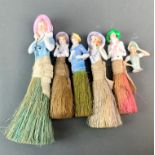 A group of six porcelain half dolls, five mounted as brushes, largest H. 20cm.