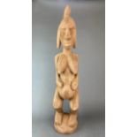 A large African carved hardwood tribal figure of mother earth, H. 82cm.