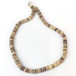 A single strand of Tibetan skull bone beads, folded L. 31cm.