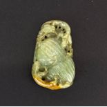 A Chinese carved celadon and russet jade amulet of two young dragons on a bitter gourd, H. 4.5cm.
