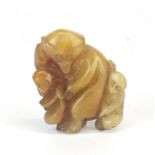 A Chinese carved russet jade amulet of a monkey mother with two young, H. 4cm.