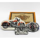 A boxed Harley Davidson watch and two metal belt buckles.