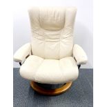 A Stressless Ekornes reclining leather armchair on a revolving base, H. 103cm.