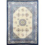 An oriental design blue and cream ground wool rug, 338 x 243cm.