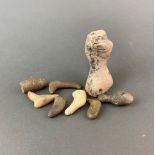 A group of stone items, understood to be stone age tools and a bead. Largest 10cm.