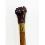 A First World War walking cane with wooden carved hand and grenade handle and other decoration, L.