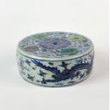 A Chinese hand painted porcelain circular scroll weight or incense holder, Dia. 9cm.
