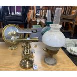 Two brass oil lamps and three gilt brass desk lamps and a mirror.