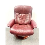 A Stressless Ekornes reclining leather armchair on a revolving base, H. 99cm.