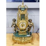 A French gilt brass and green marble mantel clock with enamelled numerals, H. 61cm.