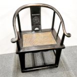 A Chinese stained hardwood and cane horsehoe chair, H. 90cm.