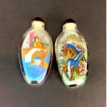 Two Chinese inside painted snuff bottles, H. 9.5cm.