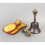 A Tibetan bronze temple bell dorje with silk carrying case, bell H. 17cm.