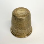 A sterling silver thimble shaped spirit cup engraved 'just a thimble full' H. 4.2cm.