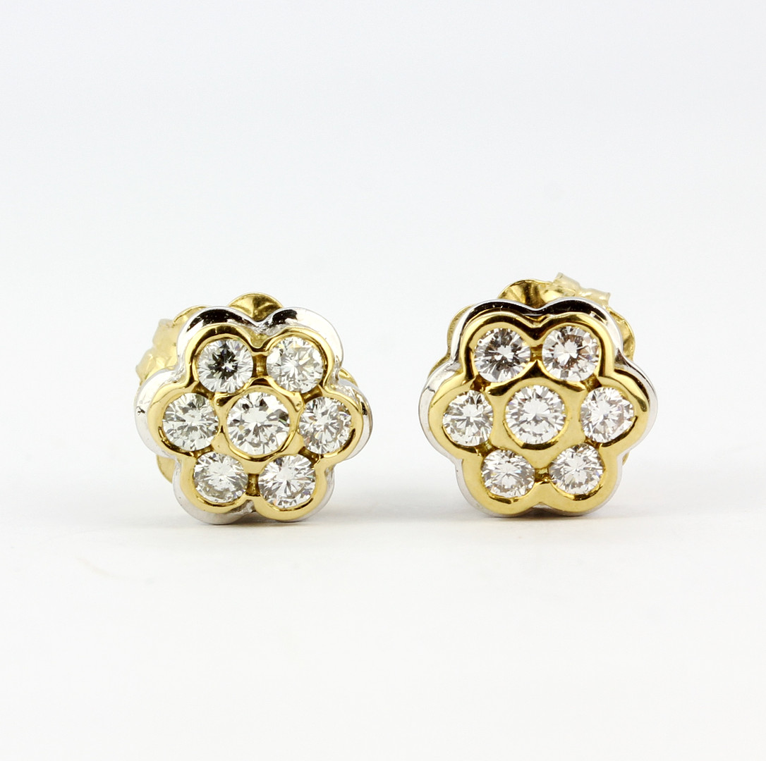 A pair of yellow and white metal (tested high carat gold, minimum 18ct) daisy cluster stud