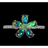 A 925 silver flower shaped ring set with cabochon cut opals, emeralds and white stones, (O.5).