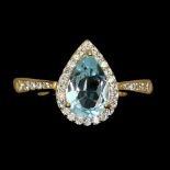 A matching gold on 925 silver ring set with pear cut blue topaz and white stones, (O.5).