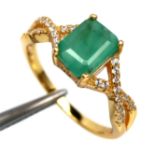 A gold on 925 silver ring set with an emerald cut emerald and white stone set shoulders, (N.5).