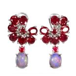 A pair of 925 silver drop earrings set with oval cut rubies and cabochon cut opals, L. 2.8cm.