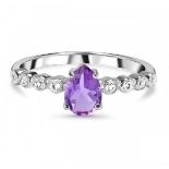 A 925 silver ring set with a pear cut amethyst and white stone set shoulders.